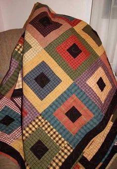 a multicolored quilt sitting on top of a chair