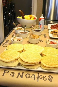 an assortment of food is displayed on a table with the words pancake shop written on it