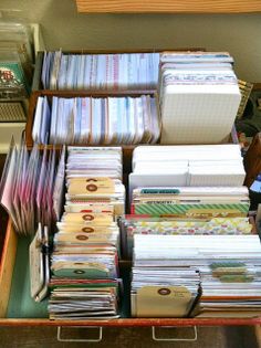 a drawer filled with lots of papers on top of a table