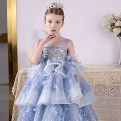 Dress your little one like a princess in our Dreamy Vow Luxury Dubai Flower Girl Dress! With exquisite beading, feather detailing, and a tiered princess gown, this dress is perfect for birthdays, weddings, or any special occasion. Make her day truly magical with this stunning sky blue dress. Princess Style Ball Gown For Prom Season, Blue Princess Gown For Party, Princess Ball Gown Dress For Birthday, Princess Ball Gown For Birthday, Birthday Princess Ball Gown Dress, Princess Style Ball Gown For Birthday, Sky Blue Princess Dress, Light Blue Princess Dress For Prom, Blue Princess Ball Gown For Prom Season