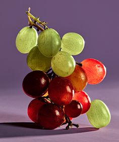 a bunch of grapes sitting on top of each other