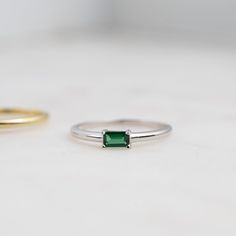 Beautifully crafted emerald ring is a true stunner! Looks great stacked or on its own! Made of 925 Sterling Silver We use a THICK plating of 14k Gold or Rhodium Available in sizes 4-10 3x5mm Baguette Stone Nickel-free & Hypoallergenic - Will not turn your fingers green! Made of the highest grade cubic zirconia for an authentic look! Classic Green Stackable Rings For May Birthstone, Classic Green Emerald Stackable Rings, Classic Green Emerald Cut Stackable Rings, Classic Green Emerald-cut Stackable Rings, Green Baguette Cut Stackable Rings, Green Emerald Stackable Ring With Baguette Cut, Classic Emerald Stackable Rings For May Birthstone, Green Baguette Cut Stackable Emerald Ring, Minimalist Emerald Cut Green Stackable Rings