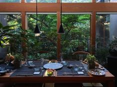 a dining room table is set with place settings