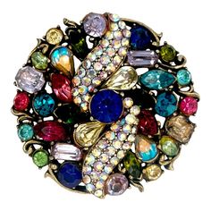 This is part of Chairish’s Costume Jewelry assortment.  This is a wonderful vintage brightly colored costume pin by the designer Hollycraft. The piece has prong set multi-color and multi shaped rhinestones. It is signed Hollycraft and looks fabulous on a coat or blazer. Condition is excellent. Dimensions; Diameter: 2", Weight: 29.4 grams Elegant Multicolor Brooch Pins, Collectible Multicolor Costume Jewelry Brooches, Vintage Multicolor Collectible Brooches, Multicolor Party Jewelry With Brooch, Vintage Multicolor Multi-stone Brooch, Unique Multicolor Collectible Brooches, Elegant Multicolor Collectible Brooches, Unique Multicolor Jewelry Brooch, Elegant Multicolor Jeweled Brooches