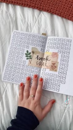 a woman's hand on top of a book with words written on the pages