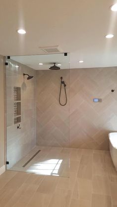 a bathroom with a walk in shower next to a bath tub