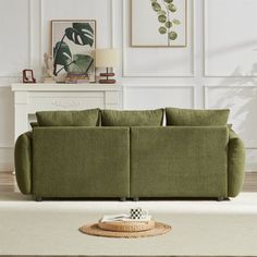 a living room scene with focus on the green couch and rug in the foreground