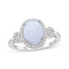 A bold lab-created opal cabochon gives this chic ring a mesmerizing look. Crafted in sterling silver The oval-cut lab-created opal centerpiece is haloed by white lab-created sapphires Loops of white lab-created sapphires decorate the slender shank for added sparkle Oval Opal Rings With Polished Finish, Fine Jewelry Oval Opal Ring With Polished Finish, Oval Opal Ring With Polished Finish In Fine Jewelry, Oval Opal Ring With Polished Finish, Oval Opal Ring With Gemstone Accents, Oval Opal Rings With Gemstone Accents, White Gold Opal Ring With Gemstone In Oval Shape, Oval Opal Ring With Gemstone Accents For Anniversary, White Gold Oval Opal Gemstone Ring