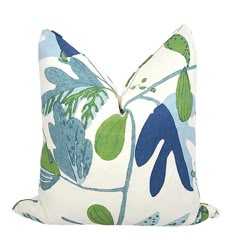 a blue and green pillow with leaves on it