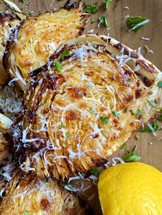 grilled artichokes with lemon and parmesan cheese on a cutting board