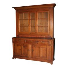 an old wooden china cabinet with glass doors on the top and bottom, against a white background