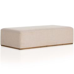 a white ottoman with brown trim on the top and bottom, in front of a white background