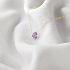 "This handmade necklace showcases a tastefully tiny Amethyst stone, securely centered on a dainty but durable chain in your preferred length and finish. All gemstones used in this necklace design are natural, and have a subtle teardrop shape - yet no two necklaces are the same. This necklace makes the perfect gift for someone with a February birthday, or any amethyst-lover in your friend or family circle. Your necklace will arrive ready-to-gift in an elegant organza jewelry pouch enclosed in a j Organza Jewelry, Necklace Length Guide, Assemblage Necklace, Family Circle, February Birthday, Neck Choker, Handmade Gifts For Her, Necklace Design, Cameo Necklace