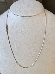 Featuring a smooth, fluid look and bright finish, this round sterling silver seamed snake chain necklace is a great option for pendants that benefit from a strong, slender chain. Seamed snake chain is created with soldered, machine-made curb-style chain that is compressed twice, producing the snake-like appearance and leaving behind a telltale seam visible along its length. This chain is plated with fine silver to ensure a bright white color and to help protect against tarnish. A lovely chain to White Gold Snake Chain Jewelry With Lobster Clasp, Silver Snake Chain Jewelry With Delicate Chain, Silver Snake Chain Necklace Gift, Classic Silver Snake Chain Necklace With Adjustable Chain, Silver Snake Chain Necklace With Adjustable Chain, Sterling Silver Snake Chain Necklace With Lobster Clasp, Sterling Silver Delicate Snake Chain Necklace Gift, Silver Delicate Snake Chain Necklace, Silver Snake Chain Jewelry