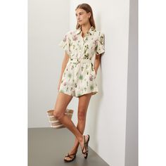 Off-white with graphic print (100% Linen). Romper. Short sleeves. Collared neckline. Front button closure. 21" from shoulder to hemline. 3" inseam. Imported. Summer Daywear Jumpsuits And Rompers With Short Sleeves, Summer Daywear Short Sleeve Jumpsuits And Rompers, Summer Short Sleeve Jumpsuits And Rompers For Daywear, Spring Workwear Jumpsuits And Rompers, Short Length, Summer Workwear Jumpsuits And Rompers In Short Length, Printed Short Sleeve Jumpsuits And Rompers For Spring, Summer Floral Print Relaxed Fit Jumpsuits And Rompers, Collared Jumpsuits And Rompers For Summer Vacation, Casual Floral Print Jumpsuits For Work