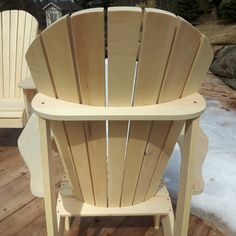 two adironda chairs sitting on a deck in the snow next to each other