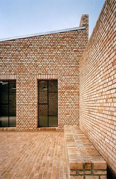 a brick building with two doors on the outside