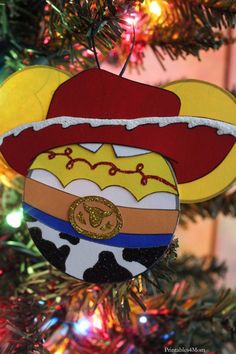 an ornament is hanging from a christmas tree in the shape of a cowboy hat