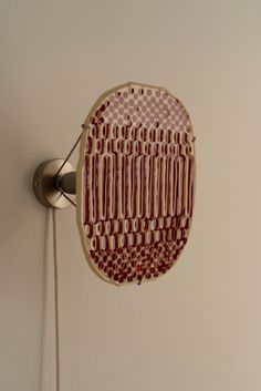 a red and white object hanging on the wall