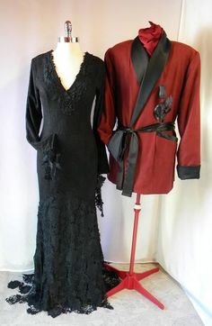 two mannequins dressed up in black and red clothing, one wearing a coat