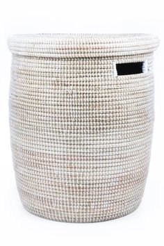 a white basket with a black handle on the front and bottom, it is made out of woven material