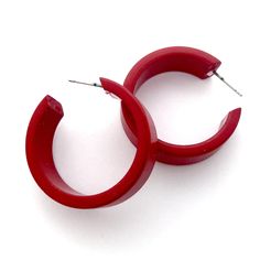 Deep red opaque lucite hoop earrings in a straight & sturdy shape with a shiny finish. This style is known as the 'Chandler Hoop' (formerly known as the Small Portland Hoop) and comes in 2 sizes. The larger one is the Portland Hoop. This is the smaller of the 2, but is in no way a small hoop. It measures about 30mm or 1.25" in diameter & 10mm in width. One of our favorite styles & comes in many colors. Jewelry is designed & hand finished by us, here in the US. Most all are made w Red Hoop Earrings, Surgical Steel Earrings, Innovative Fashion, Vintage Lucite, Cherry Red, Deep Red, Dark Red, Post Earrings, Hoop Earrings