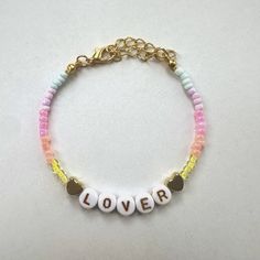 We can wear our Eras Tour Merch till January, including this Lover inspired bracelet   Disclaimer - I make these for fun. I'm not a professional! Bracelets are made to order and slight differences may occur. Clay Beads Eras Tour Bracelets, Lover Beaded Bracelet, Era Your Bracelet, Red Era Bracelet, Eras Tour Bracelets Ideas, Mad Woman Taylor Swift Bracelet, Era Bracelet, Eras Tour Bracelets