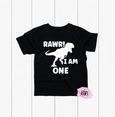 Rawr I'm One, Dinosaur Birthday, 1st Birthday Shirt, 1st Birthday, Dinosaur Shirt, First Birthday Shirt Boy, Rawr I'm One Shirt,Dinosaur Tee The design is adhered to the shirt with a premium professional heat press for optimum quality! I use TOP Quality Shirts. The shorts are NOT INCLUDED with this purchase.  The shirts are VERY SOFT!! The shirts are true to size. Shirts ship out within 1 business days (MON-FRI) or less and take an additional 2-5 days to arrive. Each shirt is custom and made special just for your little one.  Subscribe to Our Youtube Channel: BiteSizeBlessin https://www.youtube.com/channel/UCgIwKj2LgETFAzb_VbzKf2w Follow us on Instagram (@bitesizeblessin) for giveaways, exciting news, and the first to know about new products. Please verify that your mailing address is corr Three Dinosaur Birthday, Birthday Dinosaur Shirt, Third Birthday Shirt, Cookie Monster Birthday, Dinosaur Tee, Birthday Dinosaur, 2nd Birthday Shirt, 1st Birthday Shirts, First Birthday Shirts