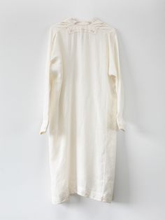 Relaxed off white linen dress with delicate light brown hand embroidery throughout. Hidden button closure at notch neck, buttoned cuffs, side seam pockets, and side slits at hem. Handmade in India. 100% Linen. Hand wash and lay flat to dry. Erica Tanov Hand Embroidered Dress, Dress For Everyday, White Linen Dress, Brown Hand, White Linen Dresses, Mid Dresses, Soft White, Embroidered Dress, Linen Dress