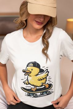 Add a touch of whimsy to your wardrobe with our unisex t-shirt featuring a cute duck riding a skateboard. Perfect for animal lovers and skateboarding enthusiasts, this trendy graphic tee is designed to bring a smile to anyone's face. Made from high-quality, comfortable fabric, this shirt is ideal for casual outings, skate park adventures, or as a unique gift. Show off your fun side with this adorable and eye-catching design. Available in multiple sizes. We utilize the authentic Bella Canvas 3001 Cool Duck, Duck Shirt, Cute Duck, Trendy Graphic Tees, Skate Park, Lovers Gift, Animal Lovers, Skateboarding, Shirt Top