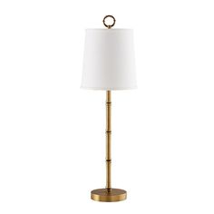 a gold lamp with a white shade on it's base and a round light fixture