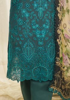 Brand: ZarqashProduct Code: ZQT 0011 DINACollection: Zarqash Tresor Unstitched Luxury Lawn CollectionFabric: Lawn DESCRIPTION “Dina ” embodies timeless elegance with its elaborate floral pattern in deep azure blue, enriched by cutwork detailing and vibrant thread work in jade and aqua green. The painstakingly embroidered border exudes opulence, elevating the ensemble to regal heights. The sumptuously printed silk dupatta adds a playful charm, infusing the look with dynamic energy. This meticulously crafted masterpiece captivates with its harmonious blend of sophistication and vivacity, enticing the beholder with its intricate beauty and luxurious allure. In “DINA,” every stitch tells a story of refined artistry and enchanting grace, making it a true symbol of sartorial excellence. DESIGN D Embroidered Trousers, Embroidered Sleeves, 3d Crystal, Cotton Trousers, Church Outfits, Azure Blue, Silk Dupatta, Slate Gray, Extra Fabric