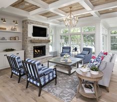 a living room filled with furniture and a fire place in the middle of a room