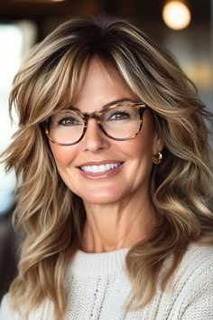 Save this pin for the best hairstyles for women over 50 with glasses. Choppy layers help waves and curls stand out, creating a fun, bouncy look. The layers work well with all face shapes and glasses styles. This cut is particularly flattering for thick hair, as it helps distribute volume evenly. Layered Hair With Bangs Chubby Face, Haircuts For Women With Long Faces, Hair With Glasses Hairstyles, Long Women’s Hairstyles, Medium Layered Hair With Side Bangs, Layered Hairstyles For Fine Hair, Hairstyles For Glasses Wearers, Hairstyles For Glasses, Cindy Spivey