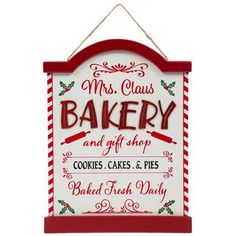 a red and white sign that says mrs claus bakery and gift shop cookies, cakes & pies baked fresh daily