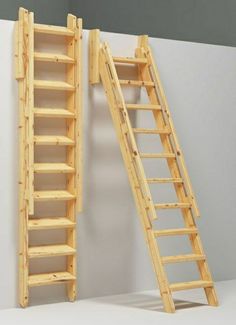 two wooden ladders next to each other in front of a white wall with a blue ribbon