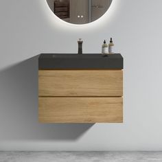 a bathroom with a sink, mirror and towel dispenser on the wall