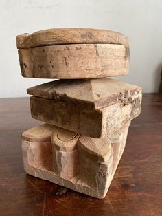 a wooden object sitting on top of a wooden table