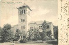 an old photo of a large building with a clock tower