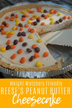 there is a pie with candy on it and the words reese's peanut butter cheesecake