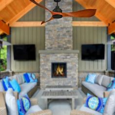 the ceiling fan is hanging in front of an outdoor fireplace