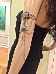 "Upper Arm Bracelet. Silver Color Arm Chains. Armlet. Body Jewelry. Draped Arm Chain. Armband. Silver Color Armlet. Body Chains. Arm Band Elegant, unique, and eye-catching armband. Fashion trend arm chains. Made of metal, silver color chains and beads. Length around arm: up to 14\". It can be extended. Contact me before placing the order. Made in USA. Designed and made by Mirela Skikic." Bohemian Silver Body Chain With Adjustable Chain, Bohemian Silver Chain Body Jewelry, Bohemian Silver Body Jewelry With Chain, Silver Bohemian Body Jewelry With Chain, Silver Bohemian Metal Body Chain, Adjustable Silver Body Jewelry With Chain Strap, Bohemian Silver Chain Bracelet With Adjustable Chain, Adjustable Metal Chain Bracelet For Festivals, Festival Metal Chain Bracelet With Adjustable Chain