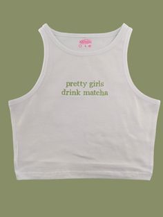 Pretty Girls Drink Matcha baby tee is embroidered on a 95% cotton/5% spandex crop top or cropped high neck racer back tank for a form-fitting fit. Available in multiple colors! Sizes run small so please check the sizing chart and order accordingly (size up if you are between sizes!) Kawaii White Top With Funny Print, White Kawaii Top With Graphic Print, Pink Kawaii Top With Funny Print, Matcha Shirt, Baby Tee With Words, Spandex Crop Top, Drink Matcha, Embroidered Tank Top, Embroidered Tank