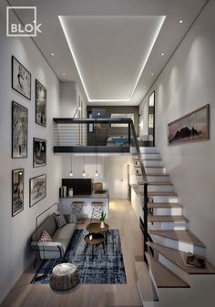 a living room filled with furniture and pictures on the wall next to a stair case