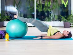 a woman is doing exercises on an exercise ball