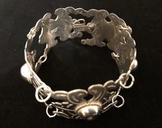 "A beautifully crafted vintage solid silver bracelet from Mexico. Made of five highly decorated curved panels connected with silver rings. Hook clasp. Designs include heavy engravings, ropes, and dimpled spheres. This piece measures 7 6/8\" in length and 1 1/8\" in width. Weight is 49.6 grams. Bracelet, circa 1930s, is in excellent vintage condition. Enjoy! *(International Buyers are welcome - however, please email me so I can check the shipping rate for you before committing to buy.) b/t" Solid Silver Bracelets, Advertising Graphics, Movie Props, Hook Clasp, Pin Jewelry, Bracelet Jewelry, Chain Link Bracelet, Link Bracelets, Chain Link