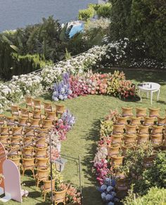 an aerial view of a flower garden with chairs and tables set up for a wedding ceremony