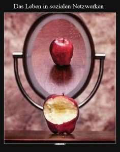 an apple sliced in half sitting on top of a wooden table