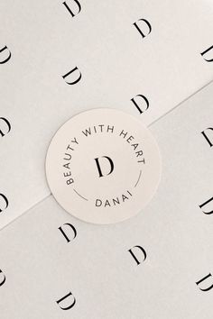 a round sticker that says beauty with heart danay on the front and bottom