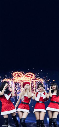 girls'generation performing on stage in santa costumes